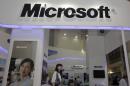 A visitor walks past a Microsoft booth at a computer software expo in Beijing