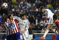 Real Madrid's Sergio Ramos (R) rises above the Atletico Madrid defence to score a goal during their Champions League final soccer match at the Luz Stadium in Lisbon May 24, 2014. REUTERS/Michael Dalder