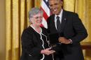 President Barack Obama awards the 2013 National Humanities Medal to Ellen Dunlap of the American Antiquarian Society, Worcester, Mass., during a ceremony in the East Room at the White House in Washington, Monday, July 28, 2014. (AP Photo/Charles Dharapak)