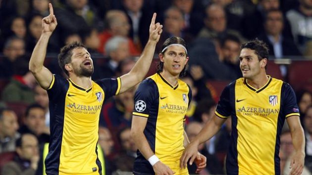 Atletico Madrid's Diego Ribas (L) celebrates beside teammates Filipe Luis and Jorge "Koke" Resurrecion (R) after scoring a goal against Barcelona during their Champions League quarter-final first leg match at Camp Nou in Barcelona April 1 (Reuters)