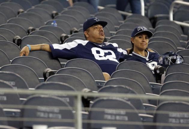 Dallas Cowboys fans sit in their seats after the team's 28-17 loss to the San Francisco 49ers in an NFL football game, Sunday, Sept. 7, 2014, in Arlington, Texas. (AP Photo/LM Otero)