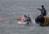 A South Korean diver enters the water near floats where the capsized passenger ship Sewol sank, during the search and rescue operation in the sea off Jindo, April 21, 2014. REUTERS/Kim Hong-Ji