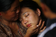 Daughter of Nepalese mountaineer Ang Kaji Sherpa, killed in an avalanche on Mount Everest, cries as her father's body is brought to the Sherpa Monastery in Katmandu, Nepal, Saturday, April 19, 2014. Rescuers were searching through piles of snow and ice on the slopes of Mount Everest on Saturday for four Sherpa guides who were buried by an avalanche that killed 12 other Nepalese guides in the deadliest disaster on the world's highest peak. The Sherpa people are one of the main ethnic groups in Nepal's alpine region, and many make their living as climbing guides on Everest and other Himalayan peaks. (AP Photo/Niranjan Shrestha)