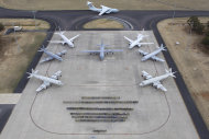 In this aerial photo taken April 29, 2014 provided by the Australia Defence Force, multinational air-crew and aircraft involved in operation "Southern Indian Ocean" are assembled for a photo at RAAF Base Pearce, in Perth, Western Australia. Seven nations, including Australia, New Zealand, the U.S., South Korea, Malaysia, China and Japan, have flew daily search mission out to the southern Indian Ocean in the massive multinational hunt for the missing Malaysia Airlines Flight 370. (AP Photo/Australian Defence Force, Cpl. Colin Dadd)
