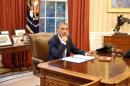 U.S. President Barack Obama reacts before he signs into law S. 517, Unlocking Consumer Choice and Wireless Competition Act, in the Oval Office at the White House in Washington,