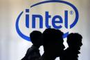 Indonesian youth walk past an Intel sign during Digital Imaging expo in Jakarta