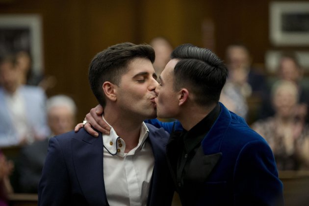Sean Adl-Tabatabai, left, and Sinclair Treadway kiss each other after they were announced officially married during a wedding ceremony in the Council Chamber at Camden Town Hall in London, minutes into Saturday, March 29, 2014. Gay couples in Britain waited decades for the right to get married. When the opportunity came, some had just days to plan the biggest moment of their lives. Adl-Tabatabai, a 32-year-old TV producer from London, and Treadway, a 20-year-old student originally from Los Angeles, registered their intent to marry on March 13, the first day gay couples could sign up for wedding ceremonies under Britain's new law. Eager to be part of history, the two men picked the earliest possible moment - just after midnight Friday, when the act legalizing same-sex marriage takes effect. (AP Photo/Matt Dunham)