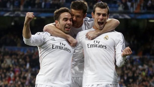 2014Real Madrid's Gareth Bale (R) celebrates with teammates Daniel Carvajal (L) and Xabi Alonso after scoring a goal against Borussia Dortmund during their Champions League quarter-final first leg