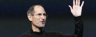 Steve Jobs waving during a presentation