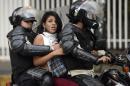 An anti-government activist is arrested by national police during a protest against Venezuela President Nicolas Maduro government in Caracas on March 13, 2014