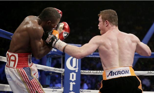 Canelo Alvarez, of Mexico, right, lands a punch on Erislandy Lara, of Cuba during their super welterweight fight, Saturday, July 12, 2014, in Las Vegas