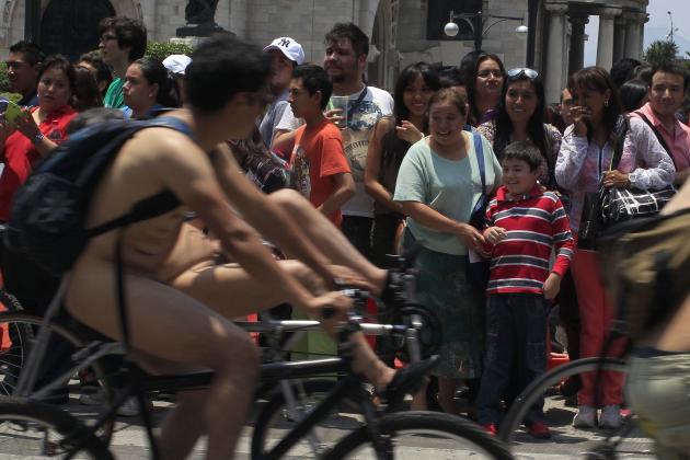 People react as riders take part in the World Naked Bike Ride in Mexico City
