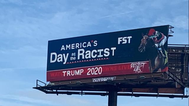 The anti-Trump graffiti artists tagged a billboard overlooking two major Kentucky highways overnight. (Credit:WHAS11)