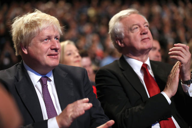 Foreign Secretary Boris Johnson and Brexit Secretary David Davis await the arrival of Prime Minister Theresa May before she delivers her keynote speech to delegates and party members on the last day of the Conservative Party Conference at Manchester Central on October 4, 2017 in Manchester, England. The prime minister rallied members and called for the party to 