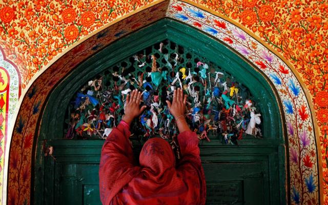 A woman prays at the shrine of Sufi Saint Khawaja Naqshband during the holy fasting month of Ramadan in Srinagar - REUTERS