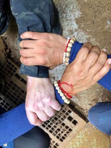 Rescuers in Thailand posted a photo of Thai and international divers linking hands before embarking on the rescue mission to save 12 boys and their soccer coach stuck in a cave, Sunday, July 8, 2018. (Royal Thai navy SEALs)