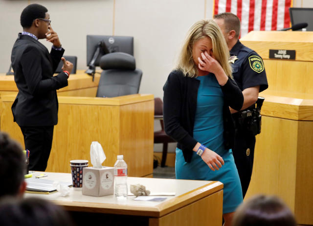 Former Dallas police officer Amber Guyger (R), who was convicted of the murder of Botham Jean, walks back to her desk after hugging Jean's younger brother Brandt Jean at the Frank Crowley Courts Building in Dallas, Texas, U.S. October 2, 2019. Tom Fox/Pool via REUTERS. MANDATORY CREDIT