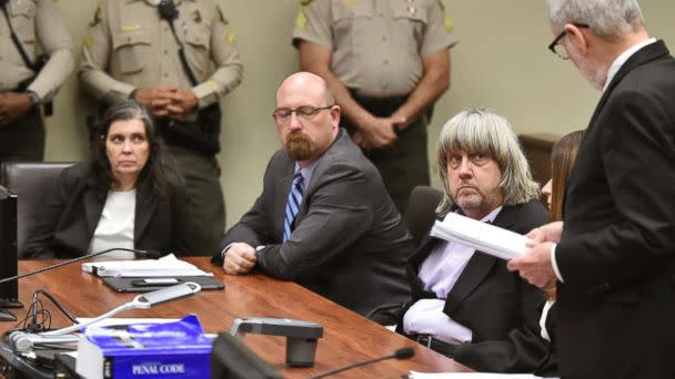 PHOTO: Louise Anna Turpin, far left, with attorney Jeff Moore, center, and her husband David Allen Turpin, listen to attorney, David Macher, as they appear in court for their arraignment in Riverside, Calif., Jan. 18, 2018. (Frederic J. Brown, Pool via AP)