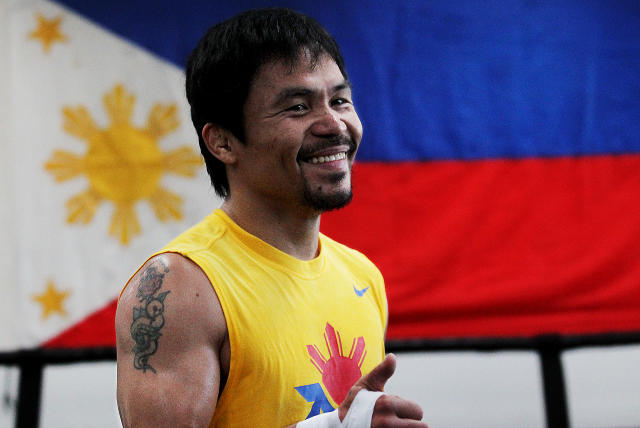 Filipino prizefighter Manny Pacquiao is framed by a flag of the Philippines as he opens training camp at the Wild Card Boxing Gym on March 9, 2015 in Los Angeles, California. (Photo: Luis Sinco/Los Angeles Times via Getty Images)