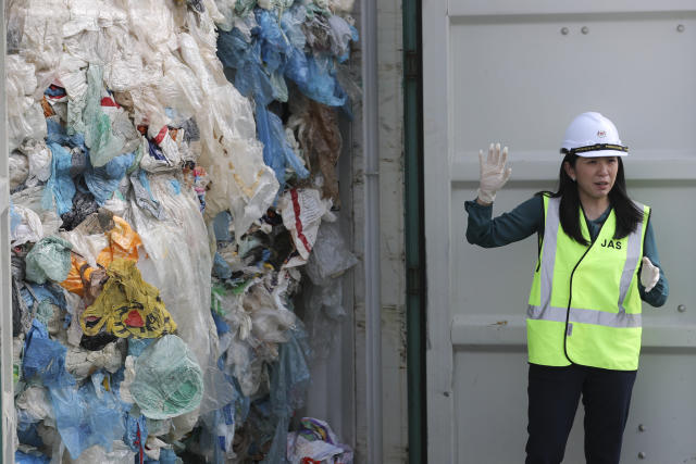 Malaysia's Minister of Energy, Science, Technology, Environment and Climate Change Yeo Bee Yin shows plastic waste shipment in Port Klang, Malaysia, Tuesday, May 28, 2019. Malaysia says it will send back some 3,000 metric tonnes (330 tons) of non-recyclable plastic waste to countries including the U.S., U.K., Canada and Australia in a move to avoid becoming a dumping ground for rich nations. (AP Photo / Vincent Thian)