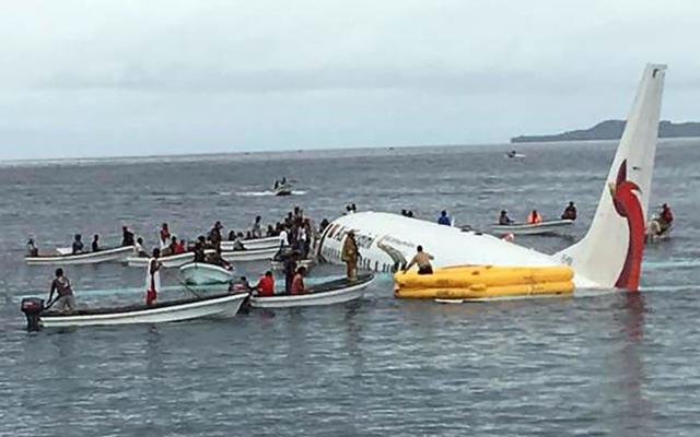 Local boats rescue passengers and crew from a 737 that ditched in the waters off the remote island of Chuuk, in Micronesia - AFP
