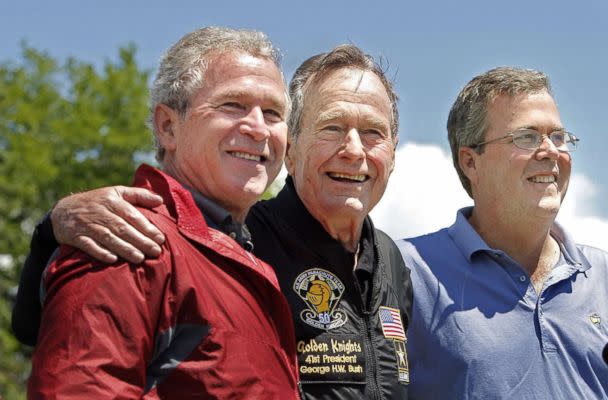 PHOTO: Former President George H. W. Bush poses with his sons, former President George W. Bush and Jeb Bush after completing a parachute jump in Kennebunkport, June 12, 2009 for his 85th birthday. (Gregory Rec/Portland Press Herald via Getty Images, file)