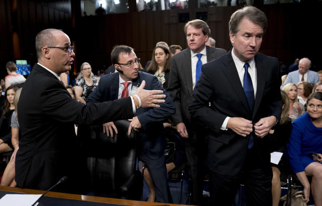 White House counsel Don McGahn, second from right, watches as Fred Guttenberg, left, father of Jamie Guttenberg, who was killed in the school shooting in Parkland, Fla., attempts to shake hands with Supreme Court nominee Brett Kavanaugh, right, as he leaves for a lunch break at a Senate Judiciary Committee hearing on Capitol Hill, Sept. 4. (Photo: Andrew Harnik/AP)