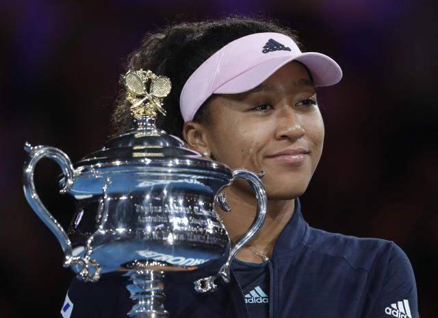 Japan's Naomi Osaka holds her trophy after defeating Petra Kvitova of the Czech Republic during the women's singles final at the Australian Open tennis championships in Melbourne, Australia, Saturday, Jan. 26, 2019. (AP Photo/Mark Schiefelbein)