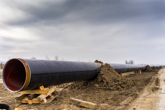 A gas pipeline under construction with a cloudy sky above.